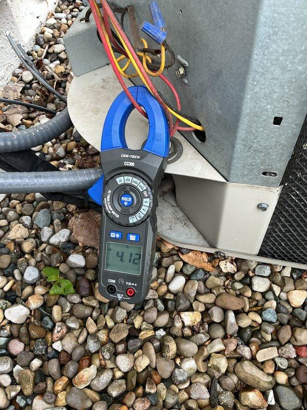 # HVAC Tune-Up Completed

Performed comprehensive tune-up on 15-year-old air conditioning system. Conducted electrical diagnostics using digital multimeter and clamp meter to verify proper component operation. Measured amp draw on compressor circuit, recording 4.12 amps, which falls within acceptable operating range for the unit. Tested capacitor connections and verified proper voltage across all electrical terminals. Inspected outdoor condensing unit including all wiring connections, relay components, and refrigerant line sets. All wire connections were secure with proper wire nuts installed on control wiring. Checked equipment mounting and confirmed unit is stable on pad with adequate clearance. Refrigerant lines showed no visible signs of damage or wear. System tested and operating normally with all electrical readings within manufacturer specifications.