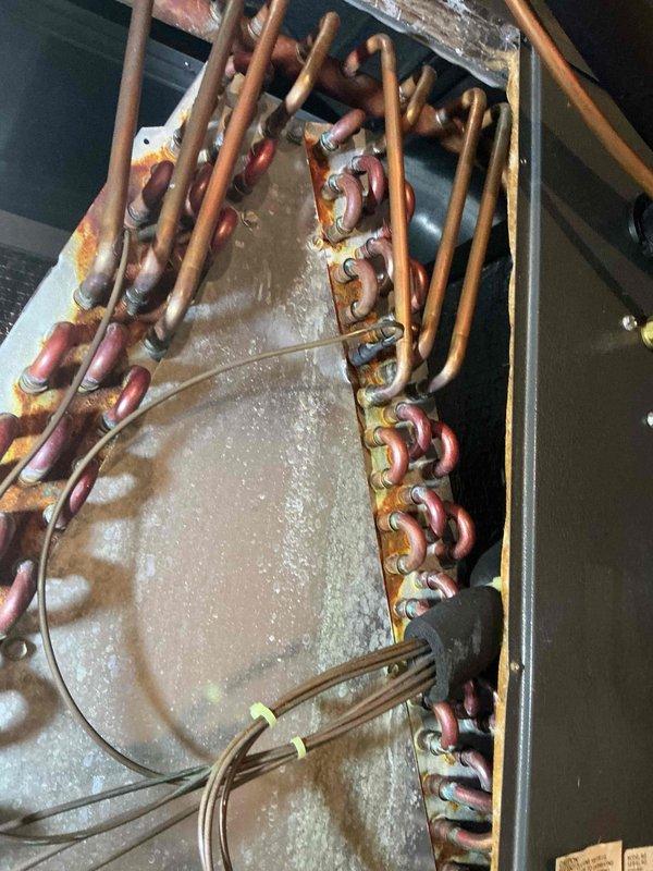 Completed scheduled heating system maintenance on furnace unit. Performed thorough inspection of heat exchanger and internal components using borescope camera to verify integrity and identify any potential issues. Examined evaporator coil assembly, copper refrigerant lines, and associated connections for signs of wear, corrosion, or leaks. Noted dust accumulation on coil surfaces and oxidation present on copper tubing connections, consistent with normal aging of equipment. All components found to be functioning properly with no immediate repairs required. System operational and ready for continued service.