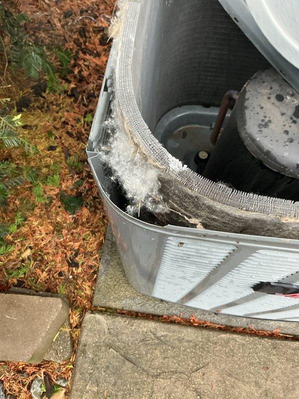Completed scheduled maintenance on 8-year-old air conditioning system. Inspected outdoor condensing unit, electrical disconnect, and contactors, noting weathered conduit connections and significant lint/debris accumulation around interior fan compartment. Cleaned unit, verified proper operation of all components, and ensured system is ready for continued service.