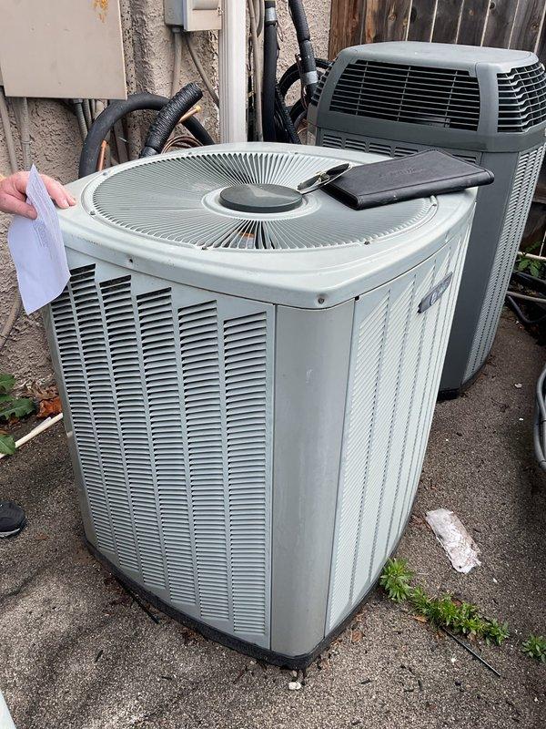 Completed comprehensive estimate for complete air conditioning system replacement at residential property. Assessed existing dual Trane HVAC system installation in mechanical room, including heating and cooling units, refrigerant line sets with insulation, gas piping infrastructure, PVC drainage system, electrical conduit connections, and ductwork plenum. Evaluated outdoor condensing unit positioned on concrete pad, noting equipment condition and accessibility for replacement. Provided detailed replacement recommendations and specifications for new AC system installation.