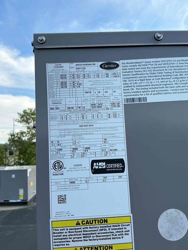 Responded to no cooling complaint for two commercial rooftop units at retail location. Accessed roof with 25-foot ladder and performed diagnostic inspection on both Carrier WeatherMaker series RTUs. Documented unit nameplate information and captured photos of equipment specifications and rooftop conditions for customer records, then contacted customer to discuss findings and coordinate payment authorization.