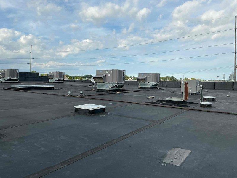 Responded to no cooling complaint for two commercial rooftop units at retail location. Accessed roof with 25-foot ladder and performed diagnostic inspection on both Carrier WeatherMaker series RTUs. Documented unit nameplate information and captured photos of equipment specifications and rooftop conditions for customer records, then contacted customer to discuss findings and coordinate payment authorization.