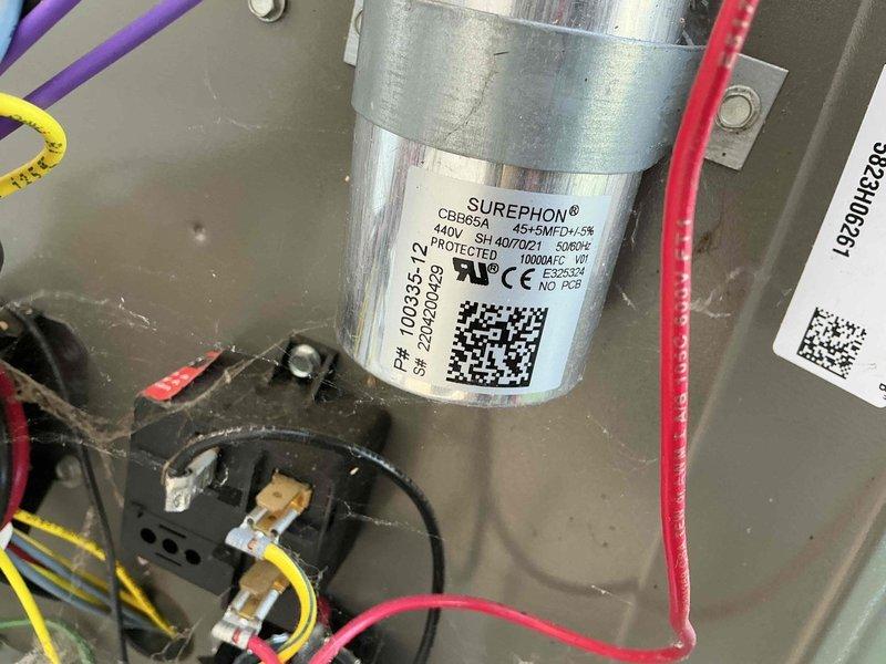 Completed comprehensive AC tune-up including inspection of electrical components, capacitor testing, and verification of all wire connections within the condensing unit. Documented SUREPHON CBB65A dual-run capacitor (440V, 45+5 MFD) and contactor assembly showing normal operating condition with all connections secure and system functioning properly.