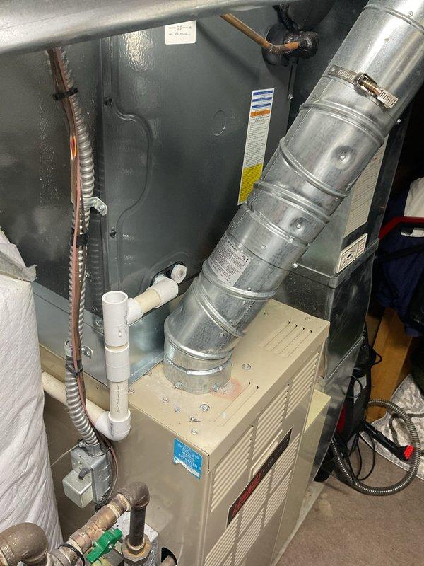 Completed comprehensive assessment of existing HVAC system and water heater for replacement estimate. Evaluated current furnace installation in utility room, including existing ductwork configuration, refrigerant lines, and condensate drainage system. Documented equipment specifications, spatial constraints, and necessary modifications for new equipment installation. Photographed vertical vent pipe routing through insulated space to assess proper venting requirements for replacement units. Provided detailed recommendations for furnace and water heater replacement, ensuring compliance with current code requirements and optimal system performance.