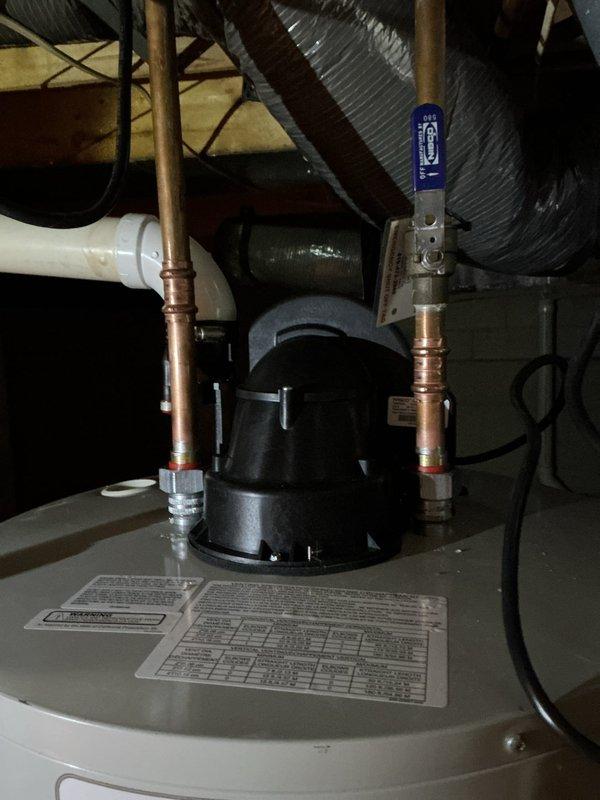 Replaced 50-gallon power vent water heater unit in crawl space with new Bradford White automatic storage water heater. Removed existing unit and installed replacement with proper copper supply line connections, power vent termination, and circulator pump assembly. All connections tested and verified operational per manufacturer specifications.