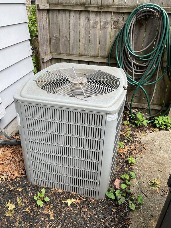 Conducted comprehensive evaluation of existing HVAC system for air conditioning replacement estimate. Assessed current equipment including American Standard Freedom 80 furnace located in basement utility area and outdoor condenser unit positioned on exterior concrete pad adjacent to residential structure. Documented existing system configuration, including ductwork connections, PVC drainage piping, and electrical service to both indoor and outdoor components. Photographed equipment specifications, model information, and installation details from manufacturer data plates. Evaluated outdoor unit placement, clearances from building structure and wooden fence, and condition of concrete pad foundation. Noted existing system layout to determine optimal replacement equipment sizing and compatibility with current infrastructure. Provided detailed estimate for complete air conditioning system replacement including removal of existing outdoor condenser unit and installation of new equipment.