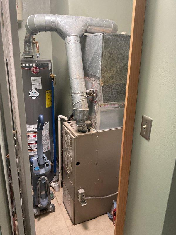 Conducted comprehensive assessment of existing HVAC system including indoor furnace unit and outdoor condensing unit to provide replacement estimate. Evaluated current Rheem-Ruud equipment configuration in utility closet, inspected ductwork connections, and assessed outdoor condenser unit condition along with associated electrical disconnect and condensate drainage system to determine replacement specifications and requirements.