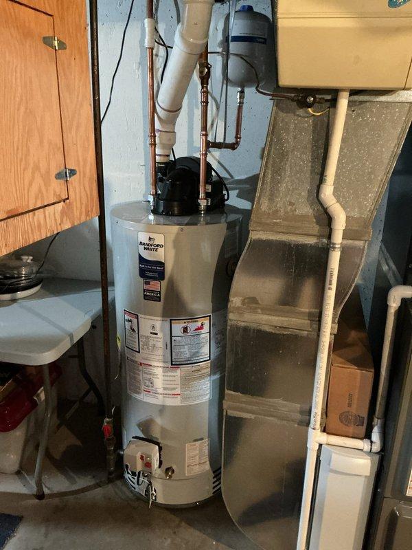 Installed 40-gallon power vent water heater in basement utility area. Connected copper supply lines with shutoff valves, routed PVC power vent piping through existing infrastructure, and installed temperature and pressure relief valve with proper discharge piping. Secured unit to manufacturer specifications, verified all connections for leaks, tested ignition sequence, and confirmed proper venting operation.