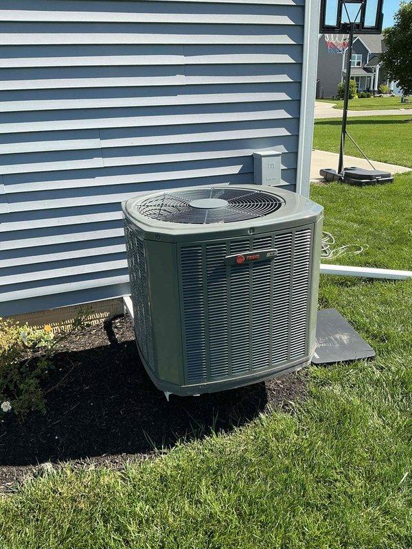 Responded to service call for noisy outdoor compressor unit on 7-year-old residential air conditioning system. Upon arrival, performed diagnostic inspection of the outdoor condensing unit and identified the issue as a failing capacitor. Removed access panel to inspect electrical components and confirmed the Dayton brand capacitor showed signs of deterioration and was causing abnormal operational noise. Replaced defective capacitor with properly rated OEM equivalent unit, secured all electrical connections, and verified proper wire routing. Tested system operation to ensure compressor started smoothly without noise, confirmed proper amperage draw, and verified cooling cycle functioned correctly. Reinstalled access panel and left system running normally.