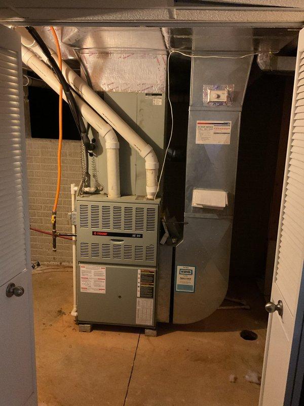 Completed comprehensive estimate for full air conditioning system replacement at residential property. Assessed existing Trane furnace and indoor air handler located in mechanical utility room, along with outdoor condenser unit positioned on concrete pad adjacent to building exterior. Documented current equipment specifications, refrigerant line routing, electrical connections, and installation conditions. Photographed existing HVAC infrastructure including ductwork, PVC condensate drainage, and equipment placement to provide accurate replacement proposal for new AC system matching current configuration and capacity requirements.