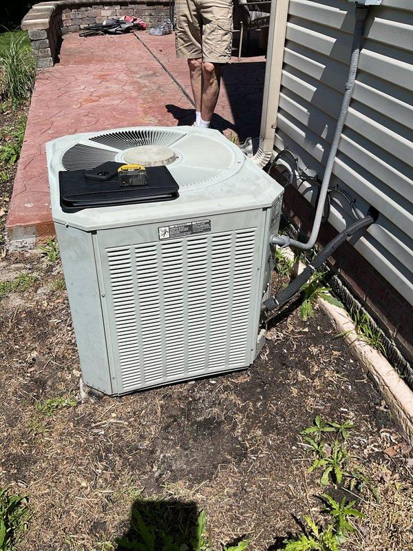 Completed comprehensive estimate for full air conditioning system replacement at residential property. Assessed existing Trane furnace and indoor air handler located in mechanical utility room, along with outdoor condenser unit positioned on concrete pad adjacent to building exterior. Documented current equipment specifications, refrigerant line routing, electrical connections, and installation conditions. Photographed existing HVAC infrastructure including ductwork, PVC condensate drainage, and equipment placement to provide accurate replacement proposal for new AC system matching current configuration and capacity requirements.
