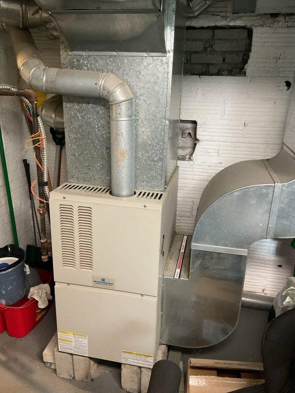 Completed comprehensive assessment of existing HVAC system for air conditioning replacement. Documented current furnace installation, electrical panel configuration, and refrigerant line routing to determine equipment compatibility and installation requirements. Evaluated basement mechanical room layout, ductwork connections, and available space for new AC condenser placement and system integration with existing forced air heating system.