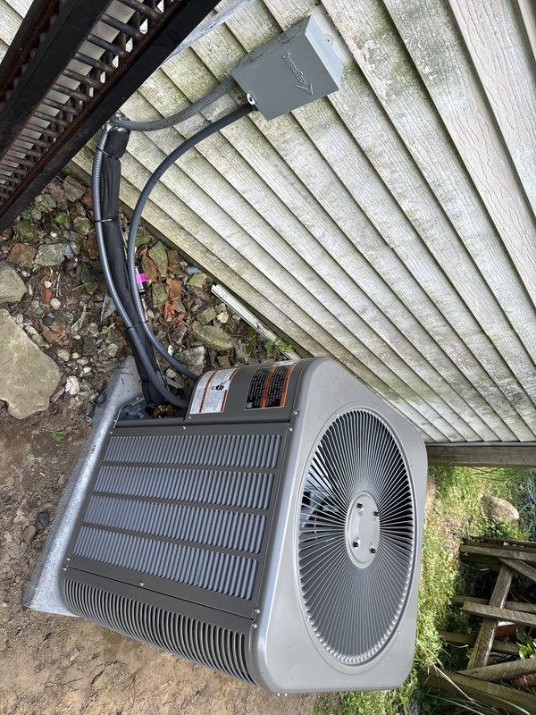 Completed full HVAC system installation including single-stage air conditioning condenser unit, upflow cased evaporator coil, and all associated components. Installed new concrete equipment pad and positioned outdoor condensing unit with proper clearances for optimal airflow and serviceability. Ran new refrigerant line set with R-410A refrigerant and flushed lines to ensure system cleanliness. Mounted new electrical disconnect box on exterior wall with weatherproof whip connection to condenser unit, ensuring code-compliant electrical service. Installed new programmable thermostat for system control. All components tested and verified operational with proper airflow, refrigerant charge, and temperature differential across the coil. System commissioned and left in full working order.