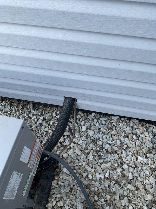 Conducted comprehensive site evaluation of existing outdoor air conditioning system for replacement estimate. Documented current equipment installation including condenser unit positioning on gravel pad adjacent to building foundation, electrical service connections, conduit routing, and meter configuration. Assessed accessibility for equipment removal and new unit installation, noting adequate clearance space and proper drainage substrate. Provided detailed replacement recommendations and specifications for new HVAC system installation.