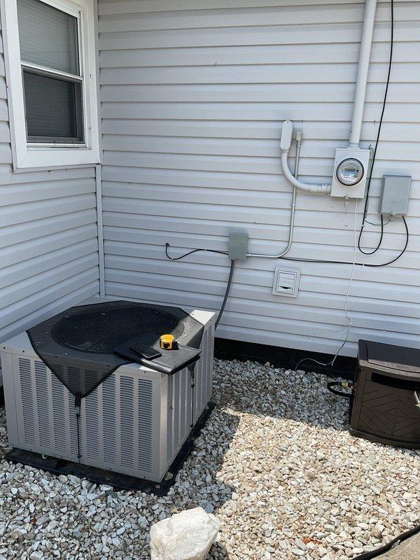 Conducted comprehensive site evaluation of existing outdoor air conditioning system for replacement estimate. Documented current equipment installation including condenser unit positioning on gravel pad adjacent to building foundation, electrical service connections, conduit routing, and meter configuration. Assessed accessibility for equipment removal and new unit installation, noting adequate clearance space and proper drainage substrate. Provided detailed replacement recommendations and specifications for new HVAC system installation.