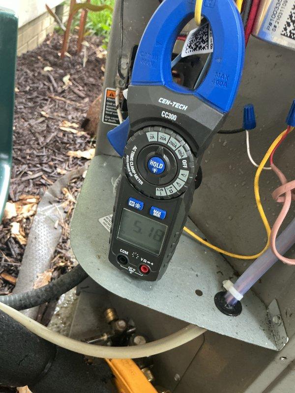 Completed preventative maintenance on 3-year-old air conditioning system. Inspected electrical connections at unit terminal blocks, noting accumulated dust and debris within panel housing. Performed amperage draw measurements using clamp meter, recording 5.9 amp reading on circuit. Cleaned electrical panel interior and connection points to ensure proper operation and prevent potential issues from environmental contamination.