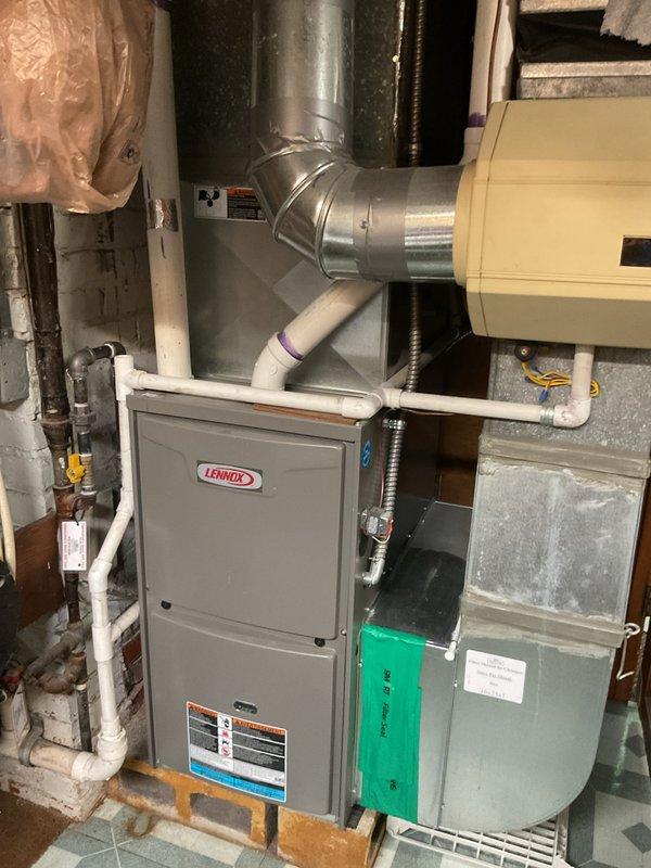 Conducted comprehensive assessment of existing HVAC system for complete replacement. Exterior condenser unit exhibited severe rust deterioration and corrosion throughout metal casing, indicating advanced age and prolonged weather exposure. Unit surrounded by overgrown vegetation and debris accumulation on concrete pad, restricting proper airflow and accelerating component degradation. Interior inspection revealed Lennox furnace system with associated ductwork, air handler components, and standard utility connections. Documented current equipment condition, configuration, and installation parameters through photographic evidence. Provided detailed replacement estimate for new AC system installation including removal of deteriorated outdoor unit, proper site preparation with vegetation clearance, and installation of modern energy-efficient equipment sized appropriately for residential application.