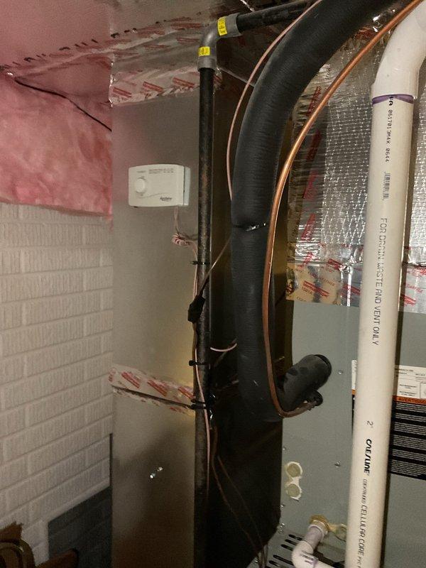 Completed comprehensive assessment of existing HVAC system for replacement estimate, including both indoor air handler/furnace unit located in attic space and outdoor condensing unit. Documented current equipment configuration, refrigerant line routing, electrical connections, ductwork layout, and installation conditions. Evaluated attic-mounted air handler with associated copper refrigerant lines, flexible ductwork, and PVC condensate drainage system. Inspected outdoor condensing unit positioned on pad against building exterior, noting refrigerant line penetrations, electrical disconnect, and conduit routing through siding. Provided customer with equipment replacement options and specifications for new high-efficiency system installation.