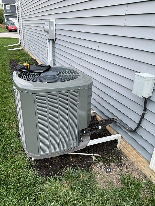 Completed comprehensive assessment of existing HVAC system for replacement estimate, including both indoor air handler/furnace unit located in attic space and outdoor condensing unit. Documented current equipment configuration, refrigerant line routing, electrical connections, ductwork layout, and installation conditions. Evaluated attic-mounted air handler with associated copper refrigerant lines, flexible ductwork, and PVC condensate drainage system. Inspected outdoor condensing unit positioned on pad against building exterior, noting refrigerant line penetrations, electrical disconnect, and conduit routing through siding. Provided customer with equipment replacement options and specifications for new high-efficiency system installation.