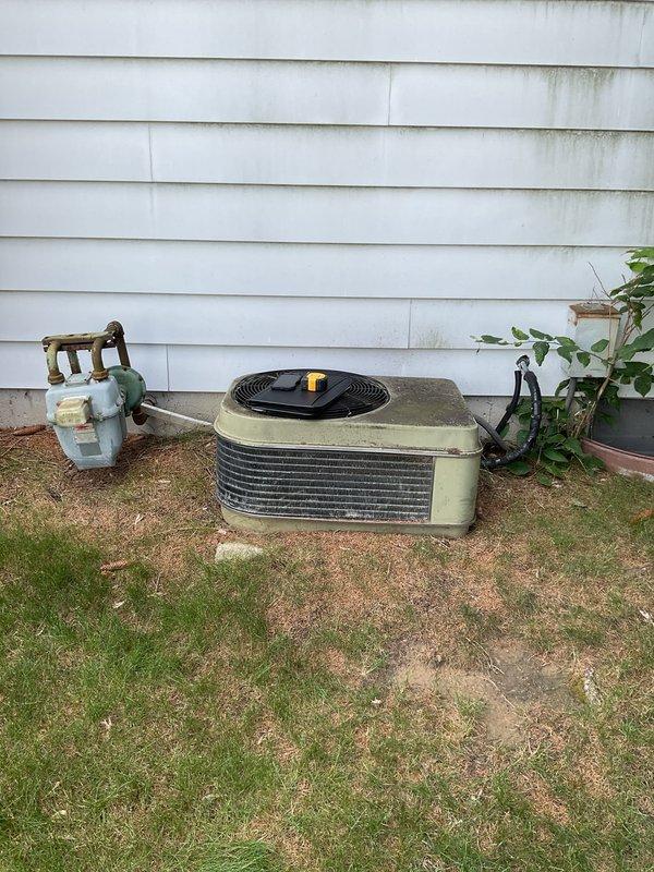 Completed comprehensive estimate for full HVAC system replacement at residential property. Assessed existing outdoor condensing unit showing significant age-related deterioration, surface discoloration, and weathering of cabinet exterior. Evaluated indoor furnace system located in basement mechanical room, noting current configuration with existing ductwork, venting system, and clearances. Documented refrigerant line set routing from outdoor unit through exterior wall penetration. Provided homeowner with equipment options and specifications for replacement air conditioning condenser and compatible system components to restore efficient cooling operation.