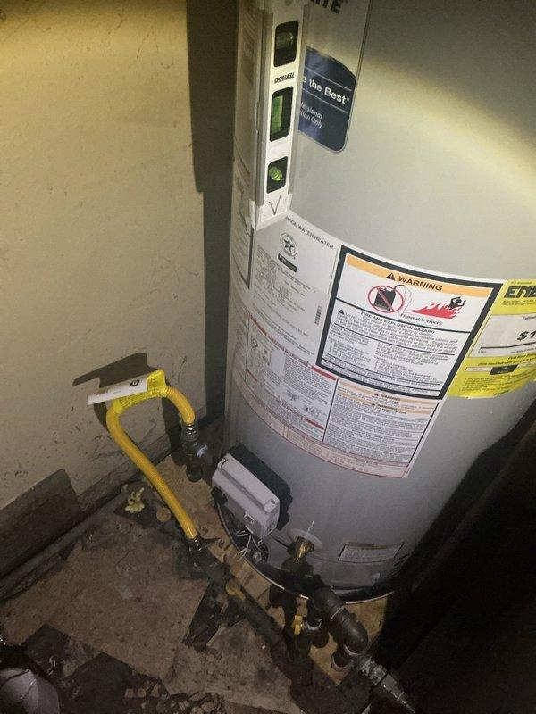 Installed a 30-gallon low-boy water heater to accommodate space restrictions in the utility area. Unit was positioned on a plywood base with drain pan for proper clearance and code compliance. Connected hot and cold water supply lines using copper piping with appropriate shutoff valves, installed exhaust venting through existing ductwork, and verified proper leveling and operational functionality. Additionally provided customer with separate quotes for bathtub mixing valve repair and toilet replacement.