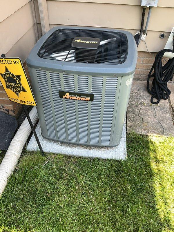 Completed seasonal air conditioning tune-up on a 6-year-old Amana condensing unit located on exterior concrete pad. Performed comprehensive maintenance inspection including evaluation of electrical disconnect with fused protection, verified proper clearances around equipment, and documented unit condition showing normal wear patterns consistent with age and outdoor exposure.