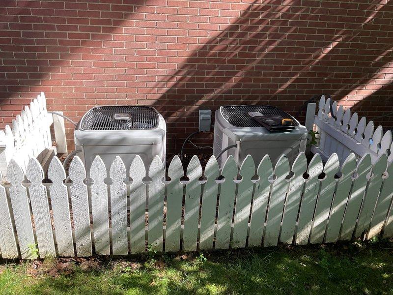 Provided estimate for replacement of right-side air conditioning condenser unit located at exterior of property against brick wall. Customer's existing condenser showing signs of age, and quote includes removal of current unit, installation of new condenser with proper refrigerant lines, electrical connections, and system testing to ensure proper operation with existing indoor Carrier furnace and air handler equipment.