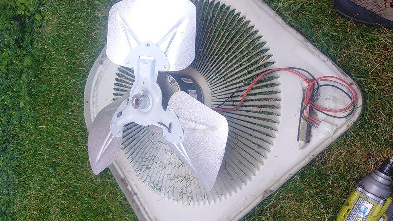 Replaced defective condenser fan motor on outdoor HVAC unit. Removed top cover to access internal components, disconnected electrical connections, and installed new motor assembly with fan blade. Verified proper operation and reassembled unit.