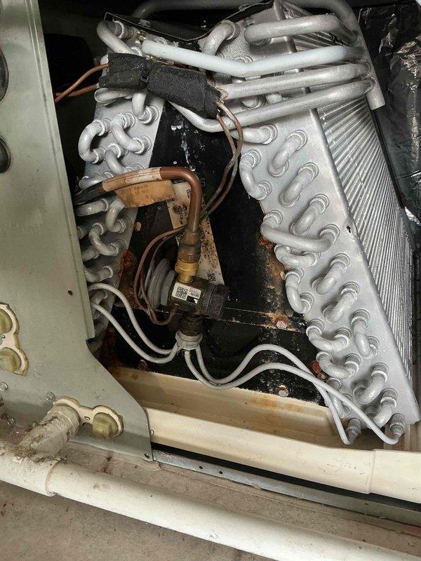 Completed comprehensive tune-up on 15-year-old residential air conditioning system. Performed standard maintenance procedures including inspection of outdoor condenser unit, verification of electrical connections at disconnect box, examination of refrigerant lines and coil assembly, and assessment of internal heat exchanger components. System found to be operational with age-appropriate wear on copper refrigerant lines and fittings noted during inspection.
