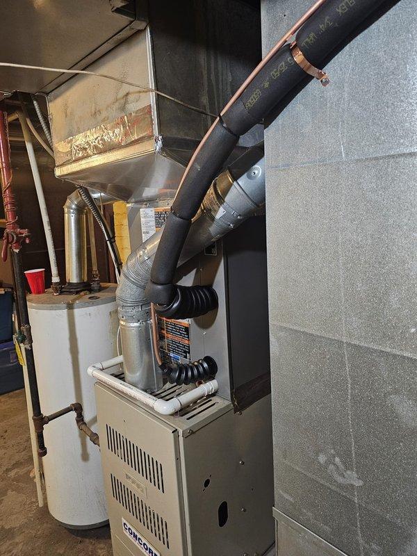 Completed full HVAC system installation including outdoor condensing unit and indoor upflow cased evaporator coil. Installed new 3/4-inch refrigerant line set with 30-foot run, positioned outdoor unit on new concrete equipment pad, and installed new electrical disconnect and whip for proper power supply. Replaced existing thermostat with new unit and commissioned system. All components tested and verified operational with proper airflow and refrigerant charge.