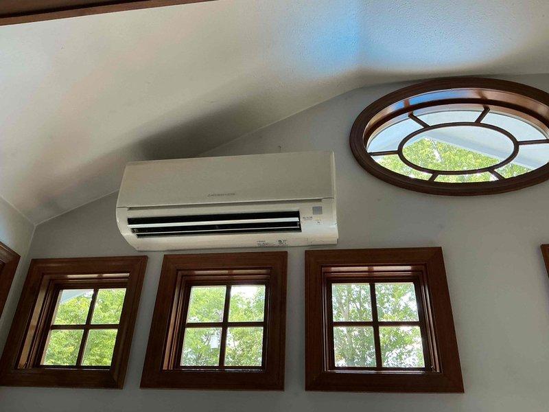 Responded to service call for 10-year-old Mr. Slim mini split system with non-operational outdoor fan in compressor unit. Upon arrival, inspected indoor wall-mounted evaporator unit and outdoor condenser unit to diagnose fan failure. Documented existing equipment installation and system configuration with photos for service records.