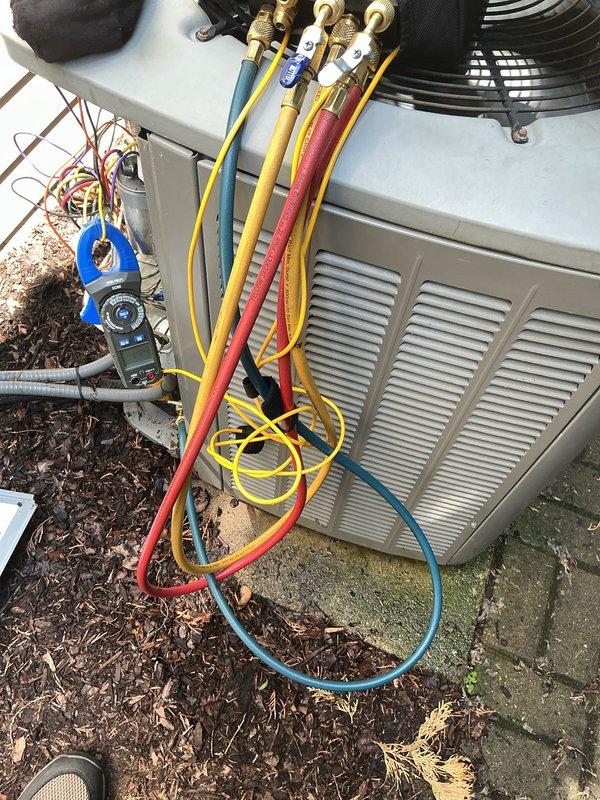 Completed routine cooling maintenance on 18-year-old HVAC system. Connected manifold gauges to outdoor condensing unit and verified refrigerant pressures and system performance. Inspected both outdoor unit and indoor air handler, checked all electrical connections, refrigerant lines, and condensate drainage systems to ensure proper operation for continued reliable cooling performance.