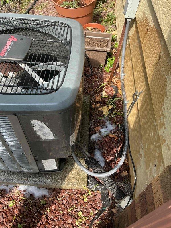 Responded to service call for 8-year-old Amana central air conditioning system not cooling properly with frequently blinking "cool on" indicator light. Upon arrival, performed diagnostic assessment of outdoor condenser unit and evaluated system operation. Inspected Amana condensing unit positioned on concrete pad, checked electrical connections at disconnect box, and verified proper airflow through coil louvers. Addressed cooling deficiency and resolved indicator light malfunction to restore normal system operation and adequate cooling performance.