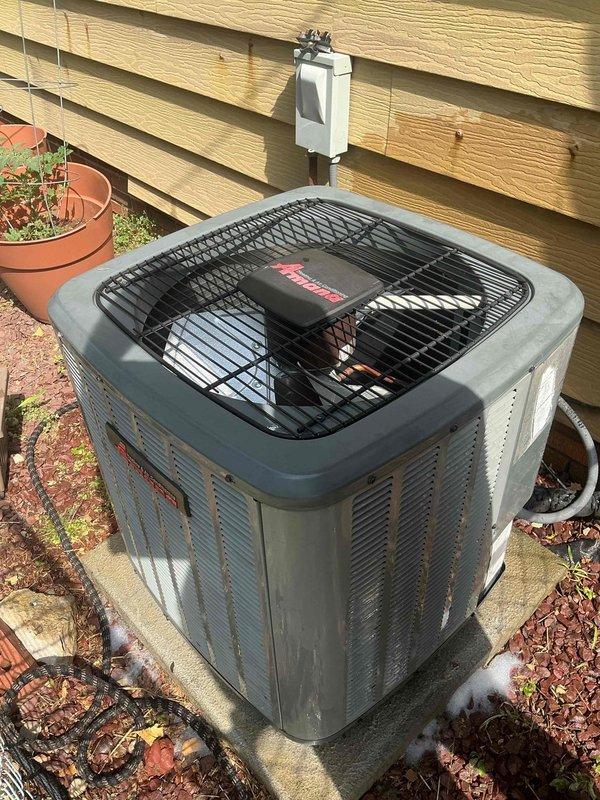 Responded to service call for 8-year-old Amana central air conditioning system not cooling properly with frequently blinking "cool on" indicator light. Upon arrival, performed diagnostic assessment of outdoor condenser unit and evaluated system operation. Inspected Amana condensing unit positioned on concrete pad, checked electrical connections at disconnect box, and verified proper airflow through coil louvers. Addressed cooling deficiency and resolved indicator light malfunction to restore normal system operation and adequate cooling performance.