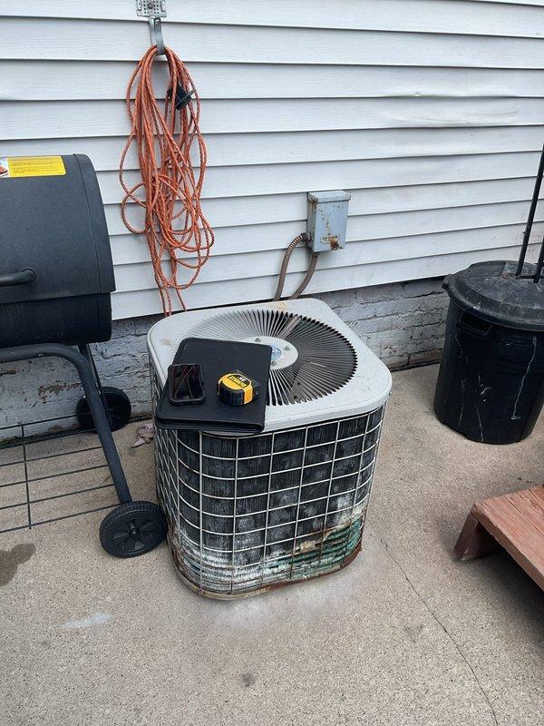 Completed comprehensive assessment of existing HVAC system for full replacement estimate. Evaluated indoor Heil furnace unit located in basement utility area and outdoor air conditioning condenser unit on exterior patio. Documented current equipment condition, including weathered outdoor condenser with visible rust staining and corrosion on metal housing, copper refrigerant lines, and existing ductwork configuration with galvanized steel trunk lines. Photographed equipment specifications, clearances, electrical connections, and installation parameters to provide accurate replacement system sizing and installation requirements for complete AC system upgrade.