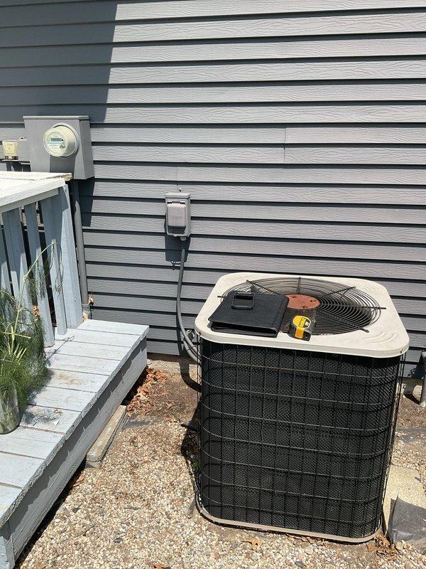 Conducted comprehensive assessment of existing HVAC system for complete replacement of both air conditioning and furnace units. Evaluated current equipment configuration in basement mechanical room, including existing furnace with connected ductwork and wall-mounted air handler components. Inspected outdoor condenser unit positioned on gravel pad against building exterior, noting electrical service connections and existing installation parameters. Documented equipment specifications, ductwork layout, electrical requirements, and site conditions through detailed photography to develop accurate replacement proposal. Provided estimate for new system installation including proper sizing calculations based on existing infrastructure and space requirements.