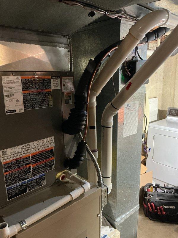 Completed installation of 13 SEER single-stage air conditioning system including upflow cased B-width evaporator coil with required sheet metal transitions. Installed new 3/4-inch lineset spanning 30 feet, relocated outdoor condensing unit 3 feet from electrical meter onto new equipment pad, and provided new disconnect box with whip connection. Installation concluded with programming of new thermostat for optimal system operation.