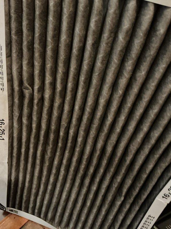 Responded to service call for 12-year-old air conditioning system running continuously with no airflow. Upon inspection, discovered severely clogged air filter restricting airflow through the system, causing the unit to operate without delivering conditioned air to the living space. Removed and replaced dirty 16x25x1 pleated air filter that showed significant dust and debris accumulation. Observed condensation buildup on ductwork and plenum surfaces, indicating proper system operation once airflow was restored. Verified blower operation and confirmed adequate airflow delivery throughout the system after filter replacement. System now cooling properly with normal airflow.