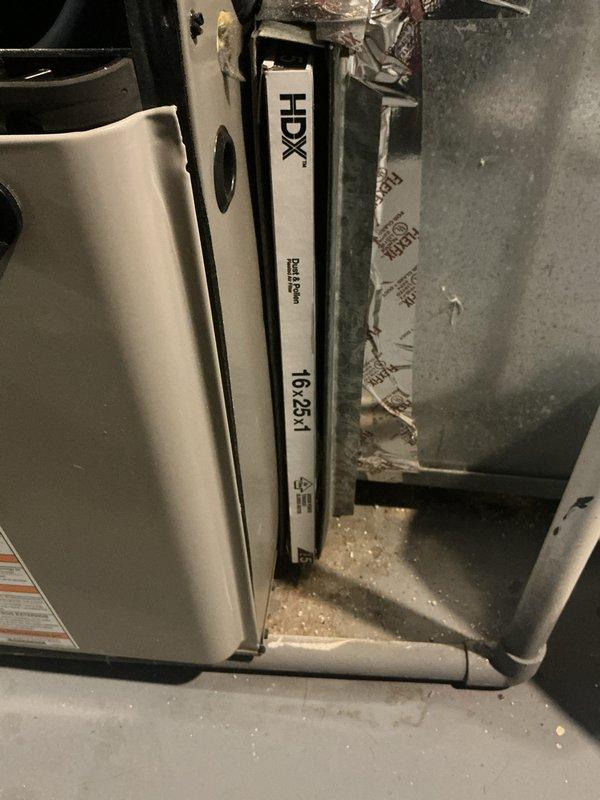 Responded to no-cooling complaint on 15-year-old central air conditioning system in recently purchased home. Upon inspection, found severely restricted airflow due to missing air filter in the Evcon furnace/air handler unit. Installed new 16x25x1 HDX filter in the filter rack and verified proper fit and seating. Confirmed system operation with adequate airflow restored to the evaporator coil and ductwork.