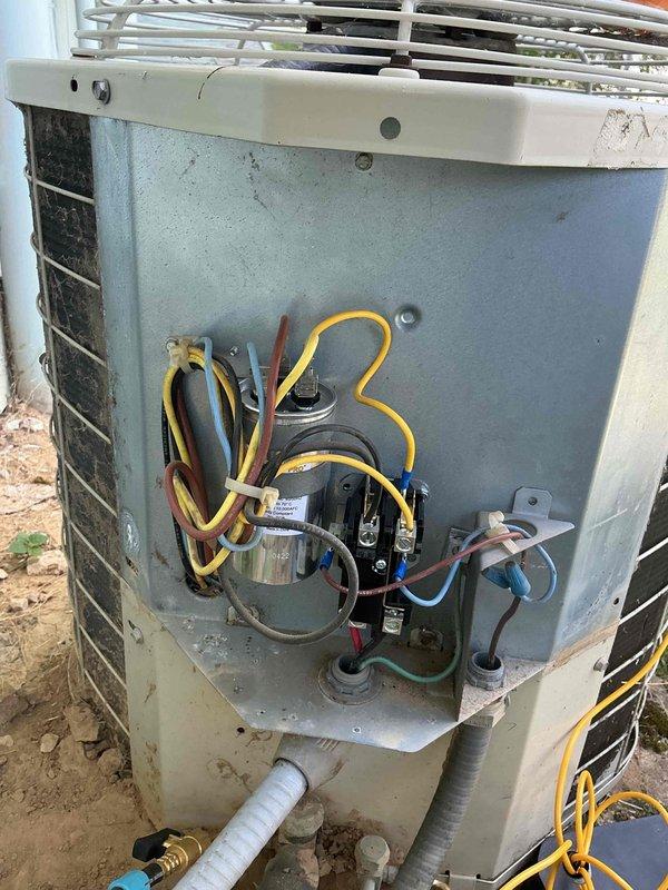 Responded to no-cooling complaint on one of three split-system air conditioning units serving individual suites. Upon inspection, confirmed condenser unit was receiving power but compressor and condenser fan motor were not operating. Air handler was running and circulating air through the space, but refrigerant system was not active. Identified failed contactor with severe corrosion and deterioration preventing proper electrical connection to compressor and fan motor. Contactor showed heavy rust, oxidation, and compromised terminal connections due to age and weather exposure. Documented electrical component condition and unit configuration for repair recommendations.