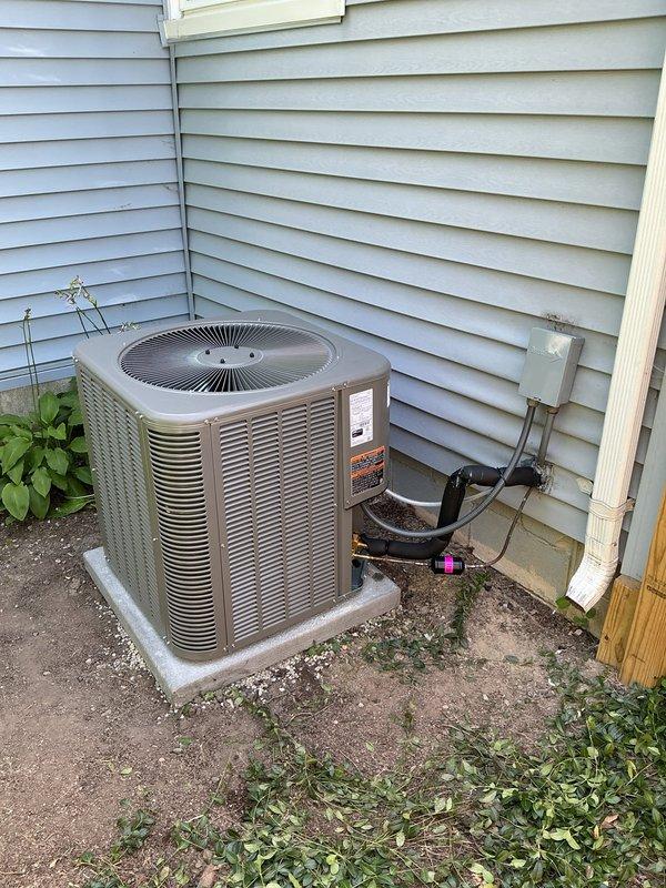 Completed full air conditioning system installation including new single-stage condenser unit, evaporator coil package, and flush metal lineset with R-11 refrigerant. Installed new concrete equipment pad, electrical disconnect box with whip connection, and programmed digital thermostat to ensure proper system operation and temperature control.