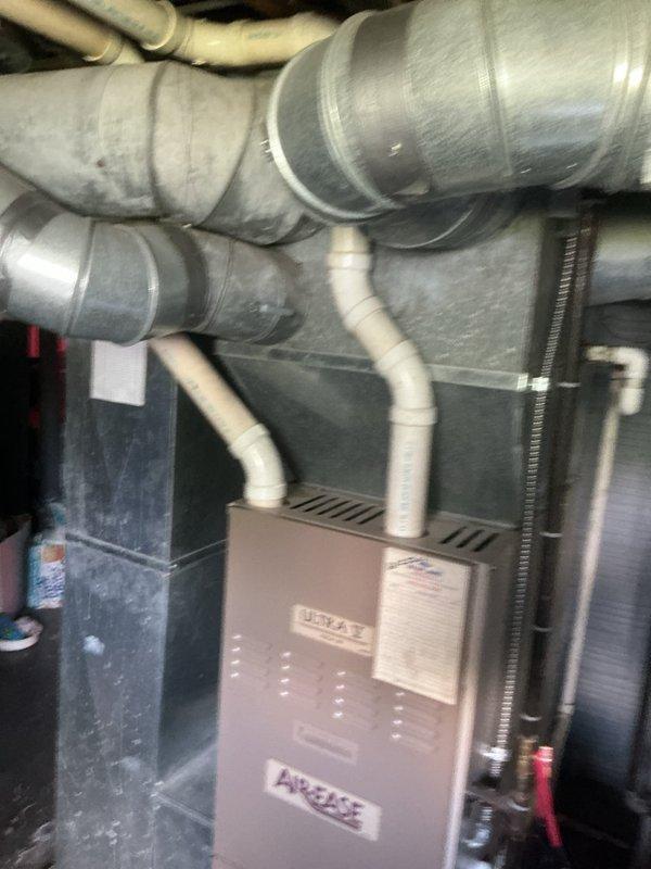 Responded to service call for 9-year-old air conditioning system experiencing water leakage from condensate piping and unit, with significant water accumulation in drain pan. Performed diagnostic inspection of HVAC system including Aire-Flo furnace and associated A/C components. Identified condensate drainage issue, inspected drain lines and pan for blockages or damage, and documented equipment condition with photographs for customer records.