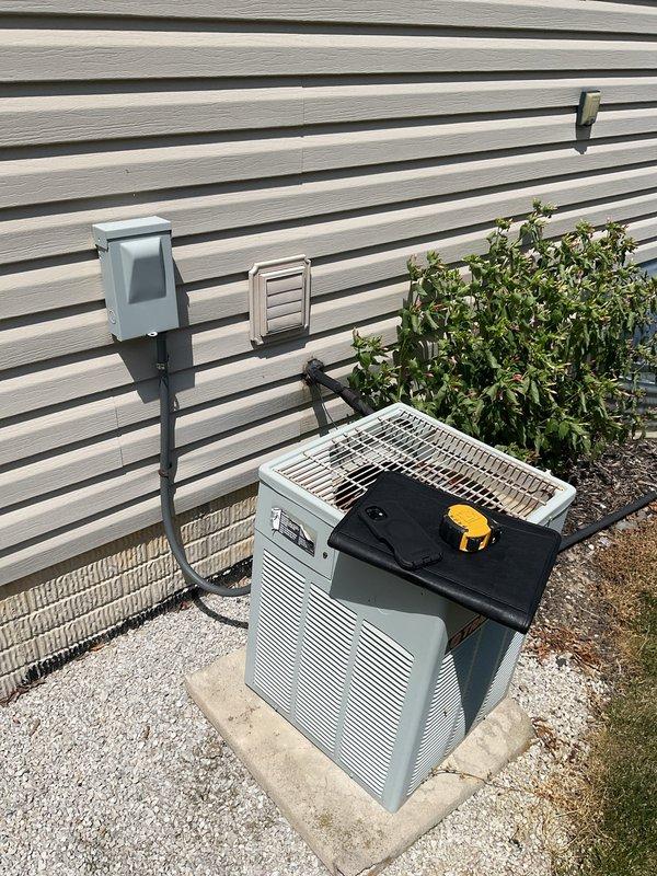 Conducted comprehensive assessment of existing HVAC system for complete replacement estimate. Evaluated outdoor air conditioning condenser unit with light gray casing positioned on concrete pad with proper gravel drainage, noting electrical disconnect box and current unit condition. Inspected indoor furnace and air handler configuration in basement utility area, documenting existing dark-colored furnace with white PVC venting system and metal ductwork components. Performed diagnostic testing using multimeter to assess current system performance and electrical functionality. Photographed existing equipment layout, installation conditions, and spatial requirements for replacement planning. Provided detailed estimate for complete AC system replacement including outdoor condenser unit and necessary modifications to existing infrastructure.