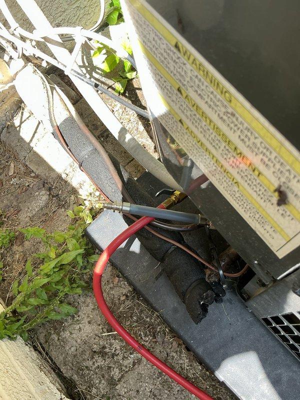 Responded to service call for air conditioning system not cooling properly. Upon arrival, performed diagnostic evaluation of outdoor condensing unit. Connected manifold gauges to service ports to check refrigerant pressures and system charge levels. Inspection revealed low refrigerant charge in the system. Added refrigerant to manufacturer specifications and verified proper operating pressures on both high and low side. Tested system operation and confirmed adequate cooling performance restored. Unit cycling properly with appropriate temperature differential across evaporator coil. System returned to normal operation with no additional issues identified.