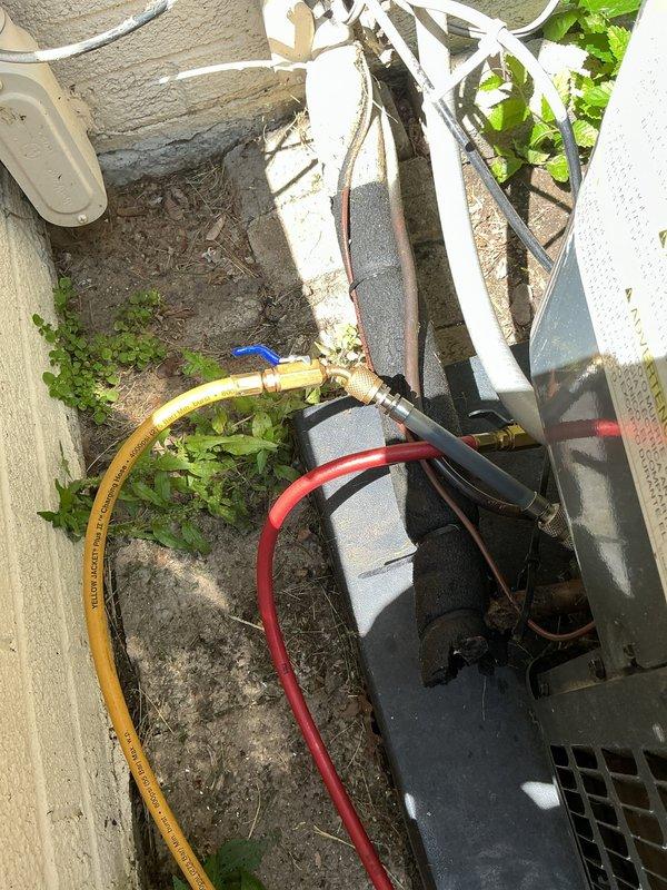 Responded to service call for air conditioning system not cooling properly. Upon arrival, performed diagnostic evaluation of outdoor condensing unit. Connected manifold gauges to service ports to check refrigerant pressures and system charge levels. Inspection revealed low refrigerant charge in the system. Added refrigerant to manufacturer specifications and verified proper operating pressures on both high and low side. Tested system operation and confirmed adequate cooling performance restored. Unit cycling properly with appropriate temperature differential across evaporator coil. System returned to normal operation with no additional issues identified.