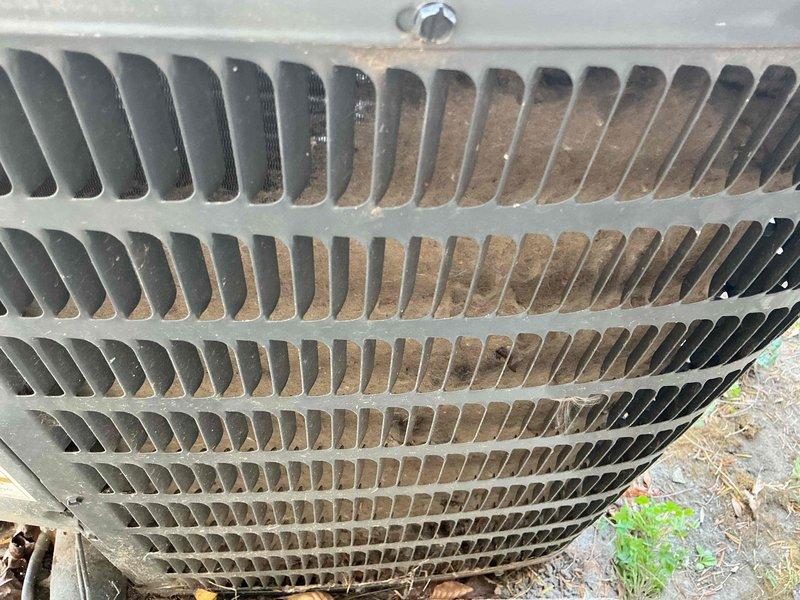 Responded to no-cooling call on recently installed air conditioning system. Upon inspection, found outdoor unit condenser coils heavily contaminated with dirt, dust, and debris accumulation, significantly restricting airflow and reducing heat transfer efficiency. Inspected electrical components including run capacitor, which showed proper connections and appeared functional. Documented unit condition with photos showing extent of coil blockage and electrical system status for service records.