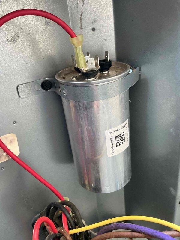 Responded to no-cooling call on recently installed air conditioning system. Upon inspection, found outdoor unit condenser coils heavily contaminated with dirt, dust, and debris accumulation, significantly restricting airflow and reducing heat transfer efficiency. Inspected electrical components including run capacitor, which showed proper connections and appeared functional. Documented unit condition with photos showing extent of coil blockage and electrical system status for service records.