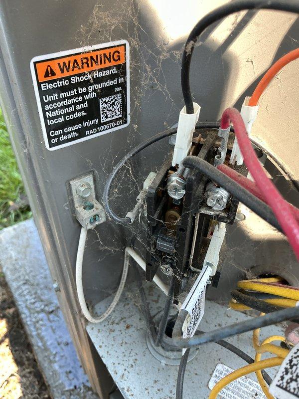 Responded to service call for residential air conditioning unit with reported fan malfunction on 5-year-old system. Upon arrival, performed comprehensive system inspection including visual assessment of outdoor condenser unit and electrical connections. Observed significant cobweb accumulation and dirt buildup on exterior electrical junction box and warning labels, indicating extended period without routine maintenance. Inspected indoor air handler wiring compartment, noting dusty conditions throughout interior components and control boards.

Tested condenser fan motor operation and verified electrical connections at both indoor and outdoor units. Examined all wire terminations at terminal blocks for proper connections and signs of overheating or corrosion. Noted some darkening at outdoor electrical terminals requiring attention. Completed preventative maintenance service including cleaning of accessible components and verification of all electrical connections. Documented equipment co