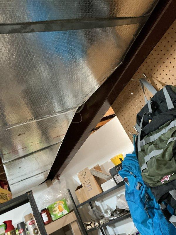 Responded to no cooling complaint on second floor with bedroom temperature at 84°F and minimal airflow from upstairs vents. Upon inspection, accessed attic space and mechanical room to evaluate air handler, ductwork configuration, and system operation. Documented HVAC equipment installation including air handler with refrigerant lines, PVC drainage system, and foil-faced insulation throughout attic area. Investigated suspected ductwork issues as reported concern, examining accessible duct runs and connections in attic space where supply distribution occurs for upper level zones. Photographed equipment and installation conditions for diagnostic reference. System appears to be original to 2012 construction with furnace filter recently replaced by homeowner prior to service call.