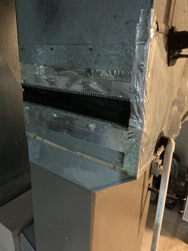 Responded to emergency no-cool call for 1970s-era air conditioning system. Upon inspection, found air handler and evaporator coil severely neglected with extensive accumulation of dust, dirt, debris, and spider webbing throughout the unit and surrounding components. Refrigerant lines showed deteriorated insulation with exposed copper tubing. Blower housing and heat exchanger fins were heavily coated with contaminants, restricting proper airflow and preventing adequate heat transfer. System condition indicated lack of routine maintenance over extended period, resulting in compromised cooling performance and unit failure. Documented equipment condition with photographs showing extent of contamination on evaporator coil, refrigerant lines, blower assembly, and filter compartment. Given the age of the equipment and severity of neglect, advised customer that system requires comprehensive cleaning or replacement to restore proper operation and efficiency.